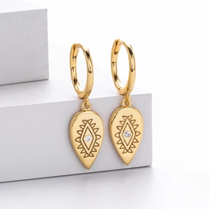 Detailed view of gold S925 silver hoop earrings with engraved totem teardrop pendants