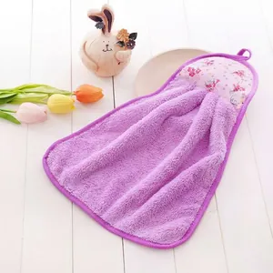 Detailed texture of purple coral fleece hanging hand towel with floral pattern top