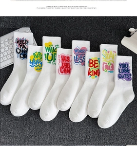 Detailed fan-shaped layout of eight white cotton sports socks with colorful graffiti quotes