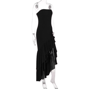 Detail of black strapless dress featuring asymmetric layered ruffle hem and slim fit