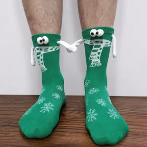 Detail of green Christmas socks with 3D hands and magnetic connection on a person