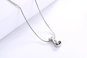 Close-up of a silver stainless steel kitten pendant with a sleek snake chain necklace