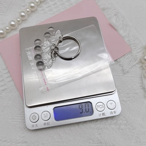 Detailed view of clear cherry keychain pendant weighing 9.0g with silver metal ring