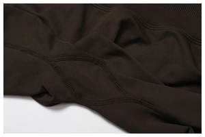 Detail of high-stretch brown knit fabric with reinforced flat seams and ribbed texture