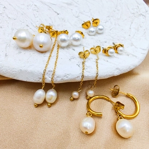 Detailed macro view of assorted freshwater pearl earrings with 14K gold plated accents