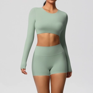 Detail of mint green seamless yoga set featuring cropped long sleeve and high waist shorts