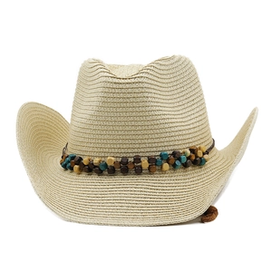 Detailed view of straw cowboy hat featuring woven texture and colorful beaded band