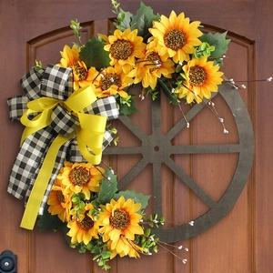 Wooden sunflower wreath with bow and berries on a door for home decoration