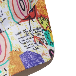 Macro shot of colorful graffiti print and twill fabric texture on the baseball cap brim