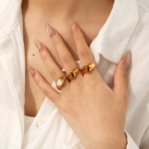 French vintage 18k gold plated heart rings with tiger eye and white shell on model