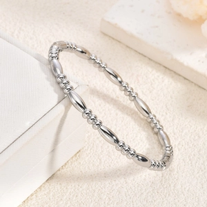 Detaillierte Nahaufnahme eines silbernen Perlenarmbands mit glatten und runden Perlen