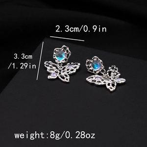 Detail view of silver hollow butterfly earrings with blue gemstones and size dimensions