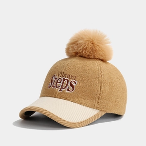 Detail of wool baseball cap with khaki pompom and Vibrant Steps embroidery