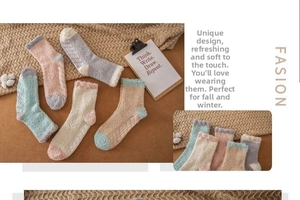 Detail of coral fleece winter socks in pastel colors on a cozy knit blanket background