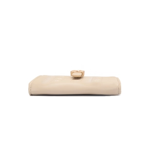 Detailed side view showing the thick structure and stitching of the beige PU leather wallet