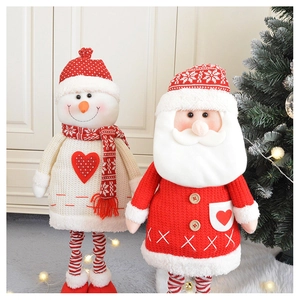 Detail of knitted Santa and snowman plush dolls with retractable legs for Christmas decor