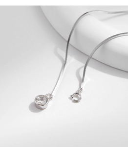 Detailed close-up of S925 sterling silver snake chain bracelet with single cubic zirconia