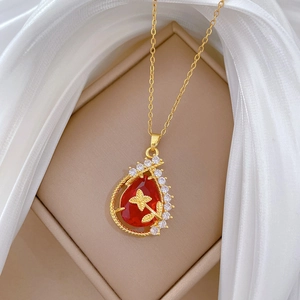 Elegant gold titanium steel necklace with red teardrop pendant and butterfly detail