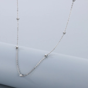 Sleek silver titanium steel necklace with elegant spaced beads on a delicate cable chain