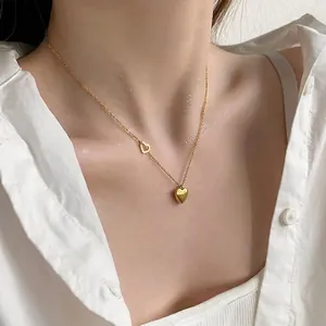 Elegant gold heart pendant necklace with double heart design on woman neck