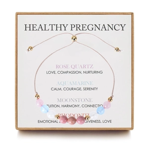 Detail of adjustable pregnancy bracelet with natural rose quartz and moonstone in a gift box