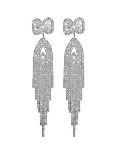 Detail of silver long tassel earrings with sparkling cubic zirconia bow and fringed chains