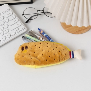 Detailed view of shrimp-shaped plush pencil case showing high storage capacity on desk