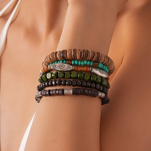 Detail view of bohemian stackable bracelets featuring wooden beads and ethnic patterns