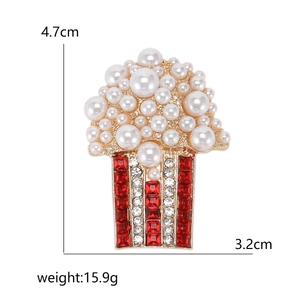 Creative popcorn brooch with pearls and red rhinestones on a gold pin base