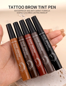 Waterproof four-tip tattoo eyebrow pens in five different shades held in hand