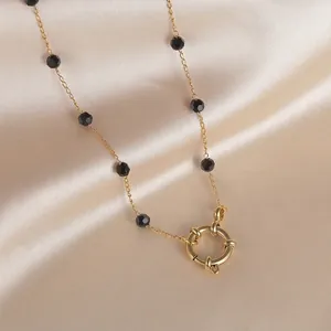 Ethical style black beaded 14K gold layered necklace with a sailor clasp and star charm