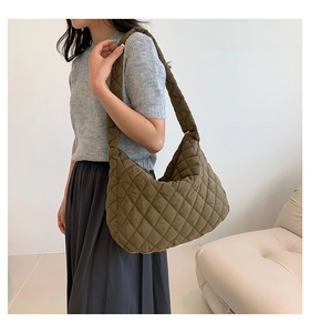 Detailed macro view of olive green quilted puffer tote bag with classic diamond stitch