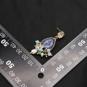 Vintage natural pearl drop earrings with blue stones and ruler for size scale reference