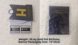 Detailed view of black and gold Happy Birthday banner with weight and size specifications