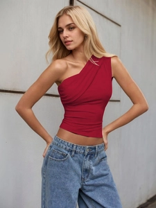 Close-up of bright red one-shoulder top with pleated texture and slim fit design