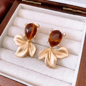 Vintage golden fish stud earrings with brown teardrop stones and textured matte finish