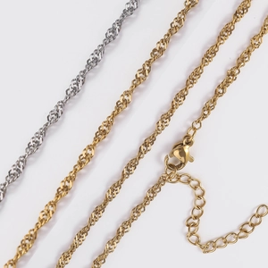 Close-up of 18K gold and silver plated stainless steel water wave Singapore chains