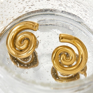Spiral textured gold stainless steel earrings shown inside a water drop glass container