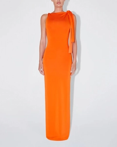 Detail of elegant orange one-shoulder dress featuring a stylish shoulder bow and slim fit cut