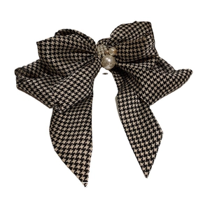 Classic black and white houndstooth hair clip with pearls on a clean white background