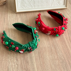 Detail of Christmas headband showing red and green fabric with pearls and crystals