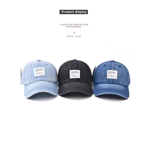 Close-up of vintage washed denim baseball caps with patch embroidery and worn details