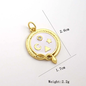 Detailed view of a gold celestial pendant with white enamel and star moon engraving