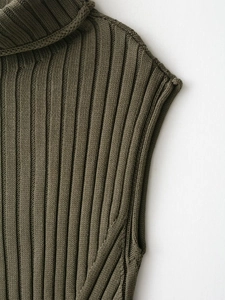 Detailed macro view of the thick ribbed knit texture on high neck sleeveless sweater