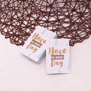 Close-up of elegant 'Have a nice Day' gift cards with geometric patterns for bouquets