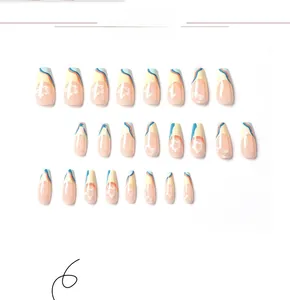 Detailed view of floral almond press-on nails with tropical blue and yellow French design