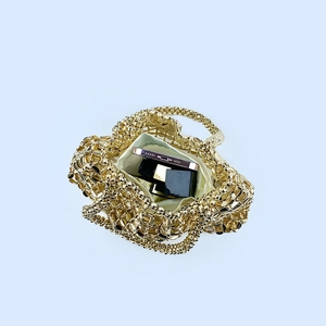 Top view of gold woven beaded handbag showing the spacious interior and light lining