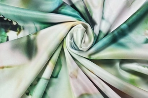 Macro shot of abstract floral printed fabric with silky texture and vibrant colors