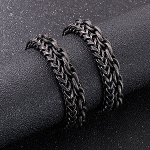 Macro shot of vintage oxidized wheat chain bracelet in stainless steel with textured links
