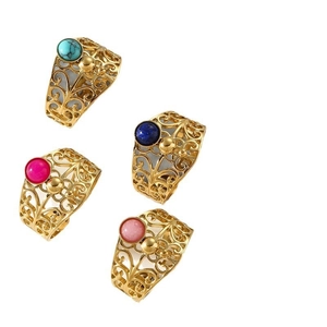 Set of four gold filigree hollow rings with turquoise and colorful stones on white background